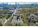 High angle aerial view showcasing lush greenery, the city skyline, and an inviting community pool at 737 Barnett Ne St # C4, Atlanta, GA 30306