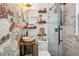 Well-appointed bathroom featuring a vessel sink, decorative wallpaper, and glass shower, combining style with functionality at 737 Barnett Ne St # C4, Atlanta, GA 30306