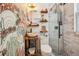Stylish bathroom with unique sink, decorative wallpaper, glass-enclosed shower, and rustic wooden shelves for storage at 737 Barnett Ne St # C4, Atlanta, GA 30306