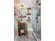Charming bathroom with custom vanity, patterned wallpaper, glass shower, and rustic wooden shelves for a spa-like feel at 737 Barnett Ne St # C4, Atlanta, GA 30306