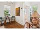 Charming dining space with hardwood floors, bright windows, and views leading into an adjacent bathroom at 737 Barnett Ne St # C4, Atlanta, GA 30306