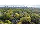 An aerial view of lush green treetops, homes and the city skyline in the distance at 1450 N Morningside Ne Dr, Atlanta, GA 30306