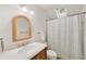 Cozy bathroom featuring a wood mirror frame, tile floors, and a shower with curtain, creating a comfortable space at 1450 N Morningside Ne Dr, Atlanta, GA 30306