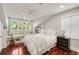 Inviting bedroom with a window seat, light paint and exposed wood flooring at 1450 N Morningside Ne Dr, Atlanta, GA 30306
