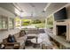 Inviting covered patio with fireplace, outdoor seating and nice view of the backyard at 1450 N Morningside Ne Dr, Atlanta, GA 30306