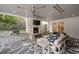 Covered patio with stone flooring, fireplace, TV, and outdoor seating at 1450 N Morningside Ne Dr, Atlanta, GA 30306