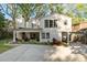 Rear exterior featuring a covered patio, lush landscaping, and a concrete driveway at 1450 N Morningside Ne Dr, Atlanta, GA 30306