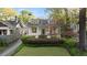 Charming two-story home with a landscaped front yard, covered entry, and mature trees at 1450 N Morningside Ne Dr, Atlanta, GA 30306