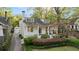 Inviting two-story home with a manicured lawn, quaint front porch, and detached garage at 1450 N Morningside Ne Dr, Atlanta, GA 30306
