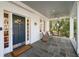 Covered front porch with bluestone pavers, fan, and comfortable seating area at 1450 N Morningside Ne Dr, Atlanta, GA 30306