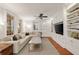 Bright living room featuring a large sectional sofa, built-in shelves, and large windows at 1450 N Morningside Ne Dr, Atlanta, GA 30306