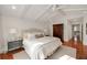 Sunlit main bedroom with wood floors features a ceiling fan and armoire, creating a cozy and inviting atmosphere at 1450 N Morningside Ne Dr, Atlanta, GA 30306
