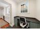 A bright home office space featuring built-in cabinets, a desk, and a window with natural light at 1450 N Morningside Ne Dr, Atlanta, GA 30306