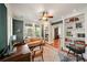 Well-lit office with built-in shelving, classic rug and glass paneled French doors at 1450 N Morningside Ne Dr, Atlanta, GA 30306