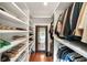Well-organized walk-in closet with shelving and hanging rods for shoes, clothes, and accessories, plus full-length mirror at 1450 N Morningside Ne Dr, Atlanta, GA 30306