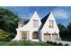 A unique two-story home with peaked roofs, large windows, a two-car garage, and beautifully maintained landscaping at 1872 Georgian Terrace, Brookhaven, GA 30341