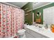 Full bathroom with a floral shower curtain and decorative wall hangings at 1920 Barrington Dr, Jonesboro, GA 30236