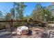 A large deck offers multiple seating arrangements, a fire pit, and a view of the woods at 1920 Barrington Dr, Jonesboro, GA 30236