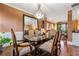 Classic dining room featuring glass table, upholstered chairs, hardwood flooring, and decorative accents at 1920 Barrington Dr, Jonesboro, GA 30236