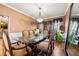Dining room featuring a glass-top table, upholstered chairs, and elegant lighting at 1920 Barrington Dr, Jonesboro, GA 30236