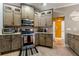 Cozy kitchen with rustic cabinets, stone countertops, stainless steel appliances, and wood flooring at 1920 Barrington Dr, Jonesboro, GA 30236