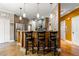 Open concept kitchen with breakfast bar, pendant lighting, wood cabinets, and stainless steel refrigerator at 1920 Barrington Dr, Jonesboro, GA 30236