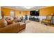 A downstairs living area boasts tiled flooring, leather furniture, and an entertainment center at 1920 Barrington Dr, Jonesboro, GA 30236