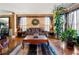Elegant living room with hardwood floors, decorative rug, large windows with natural light, and stylish decor at 1920 Barrington Dr, Jonesboro, GA 30236
