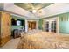 Spacious bedroom with tray ceilings, a TV, and double french doors to the backyard at 1920 Barrington Dr, Jonesboro, GA 30236