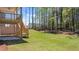 Spacious backyard with a two-level wooden deck and stairs leading down to a well-maintained lawn at 59 Tallulah Trl, Sharpsburg, GA 30277
