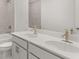 Bright bathroom featuring double vanity, modern fixtures, and shower with beautiful gray tile at 59 Tallulah Trl, Sharpsburg, GA 30277