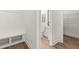 Hallway with bench seating and coat hooks leading to a half bath and pantry at 59 Tallulah Trl, Sharpsburg, GA 30277