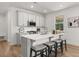 Modern kitchen features white cabinetry, stainless steel appliances, and a quartz countertop island at 59 Tallulah Trl, Sharpsburg, GA 30277