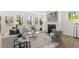 Bright living room featuring a fireplace, hardwood floors, and large windows overlooking the backyard at 59 Tallulah Trl, Sharpsburg, GA 30277