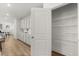 Walk-in pantry with wooden shelves, easily accessible from the kitchen and living area at 59 Tallulah Trl, Sharpsburg, GA 30277