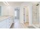 Bright bathroom with double vanity, granite countertop, wood flooring and glass enclosed shower at 806 Relic Rdg, Hampton, GA 30228