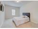 Bedroom with carpet, a gray headboard, and a window providing natural light at 806 Relic Rdg, Hampton, GA 30228