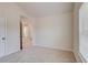 Bright, carpeted bedroom with window and access to other areas of the home at 806 Relic Rdg, Hampton, GA 30228