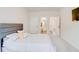 Bedroom with carpet, gray headboard; ensuite bathroom and walk-in closet can be seen at 806 Relic Rdg, Hampton, GA 30228