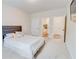 Carpeted bedroom with gray headboard; ensuite bathroom and walk in closet can be seen at 806 Relic Rdg, Hampton, GA 30228