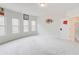 Large bonus room with neutral carpet and lots of natural light is a flexible space for a playroom or media room at 806 Relic Rdg, Hampton, GA 30228