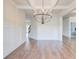 Dining room showcasing a modern chandelier, hardwood floors, and decorative wall trim at 806 Relic Rdg, Hampton, GA 30228