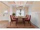 Dining room featuring a modern chandelier and a wooden dining table with six brown velvet chairs at 806 Relic Rdg, Hampton, GA 30228