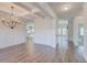 Open dining room showcasing modern chandelier, hardwood floors, and decorative wall trim at 806 Relic Rdg, Hampton, GA 30228