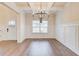 Dining room featuring a modern chandelier, large windows, and decorative wall trim at 806 Relic Rdg, Hampton, GA 30228