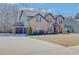 Spacious home featuring a brick facade, attached garage, and expansive driveway in a quiet neighborhood at 806 Relic Rdg, Hampton, GA 30228