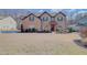 Inviting brick-front home with a manicured lawn and inviting entryway, creating a welcoming curb appeal at 806 Relic Rdg, Hampton, GA 30228
