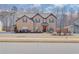 Charming two-story brick home with a well-manicured lawn and mature trees in a suburban neighborhood at 806 Relic Rdg, Hampton, GA 30228