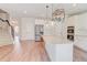 Spacious kitchen featuring stainless appliances, an island with granite counters, and access to the stairs at 806 Relic Rdg, Hampton, GA 30228