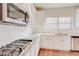 Modern kitchen with stainless steel appliances, gas range, granite counters and white subway tile at 806 Relic Rdg, Hampton, GA 30228
